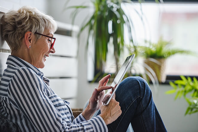 Woman Looking at Her Tablet Computer