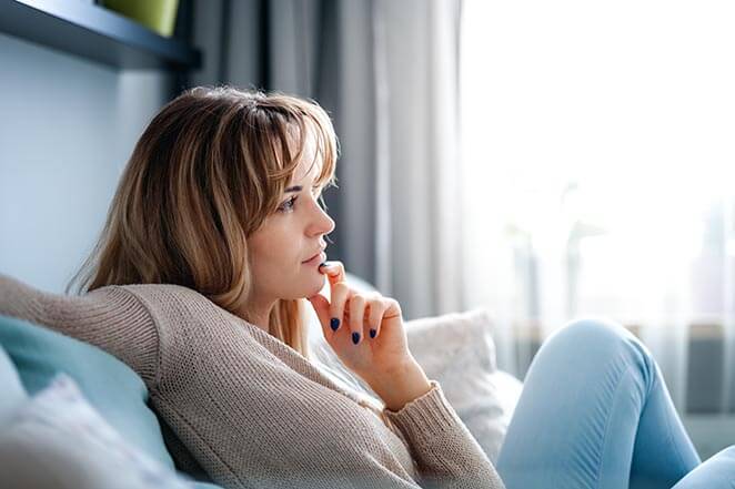 Woman Thinking on Her Couch